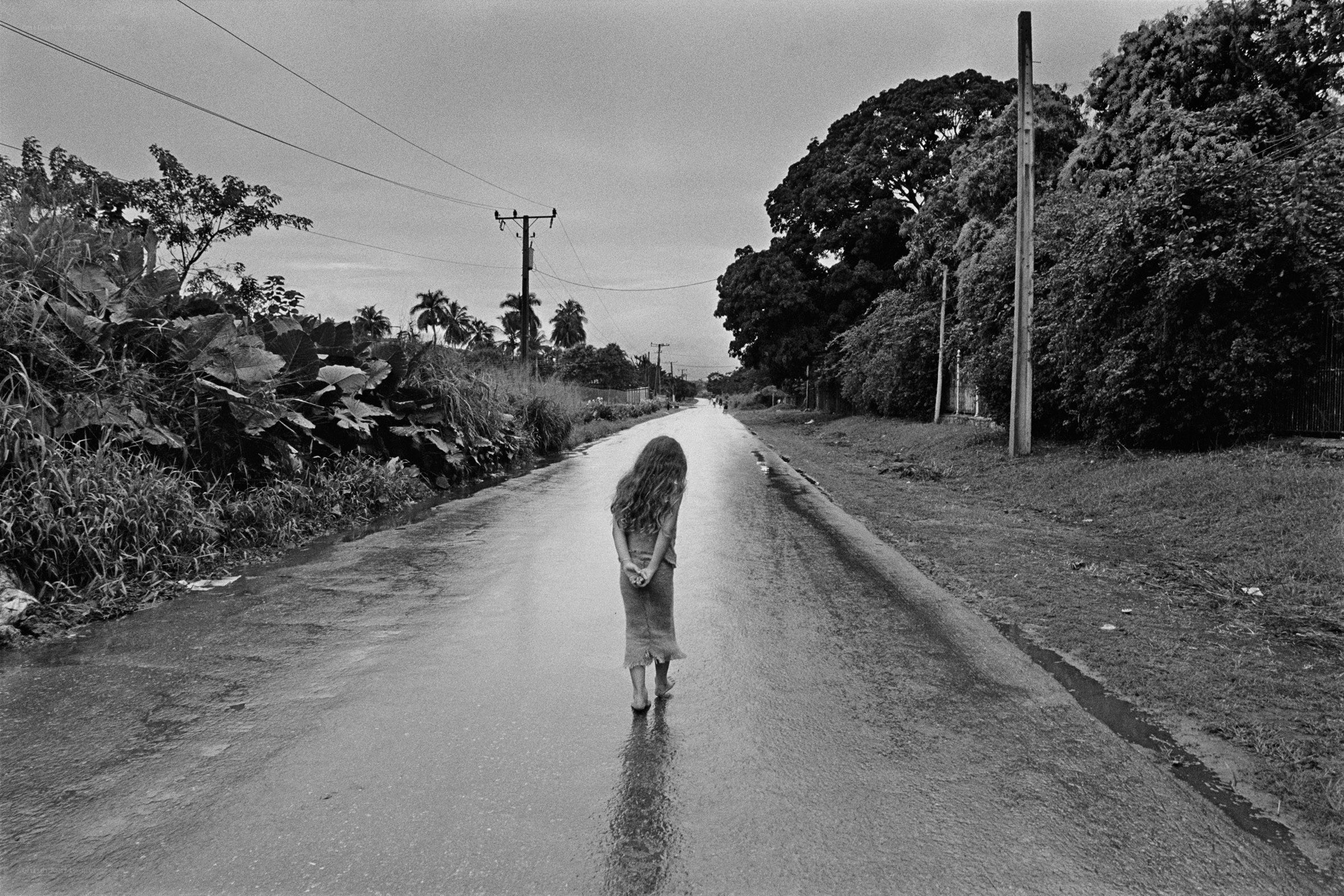 child walking on wet road