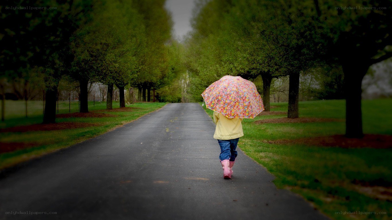 child walking with umbrella