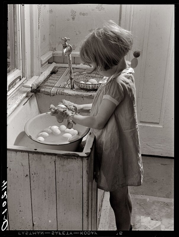 child washing eggs in sink