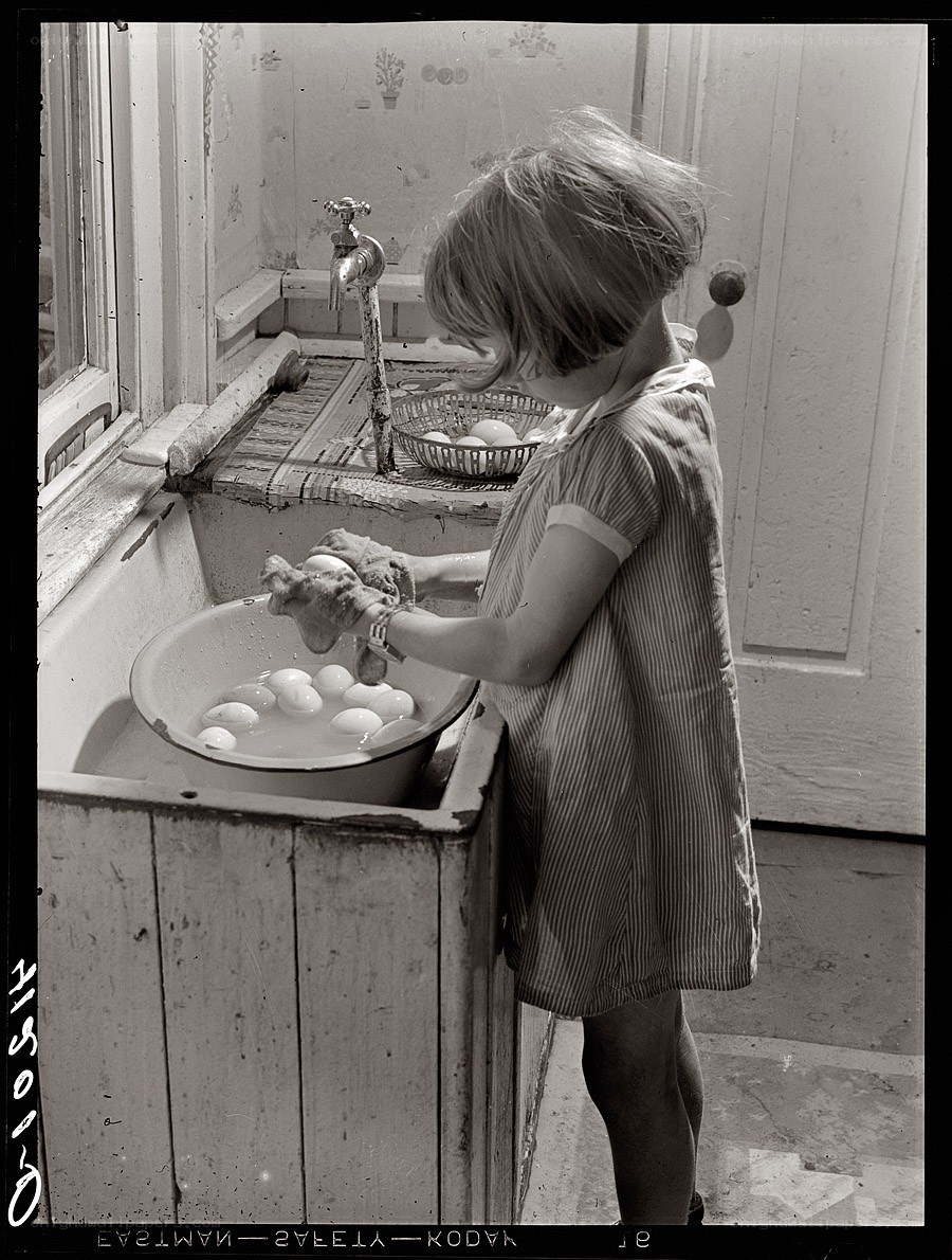 child washing eggs in sink