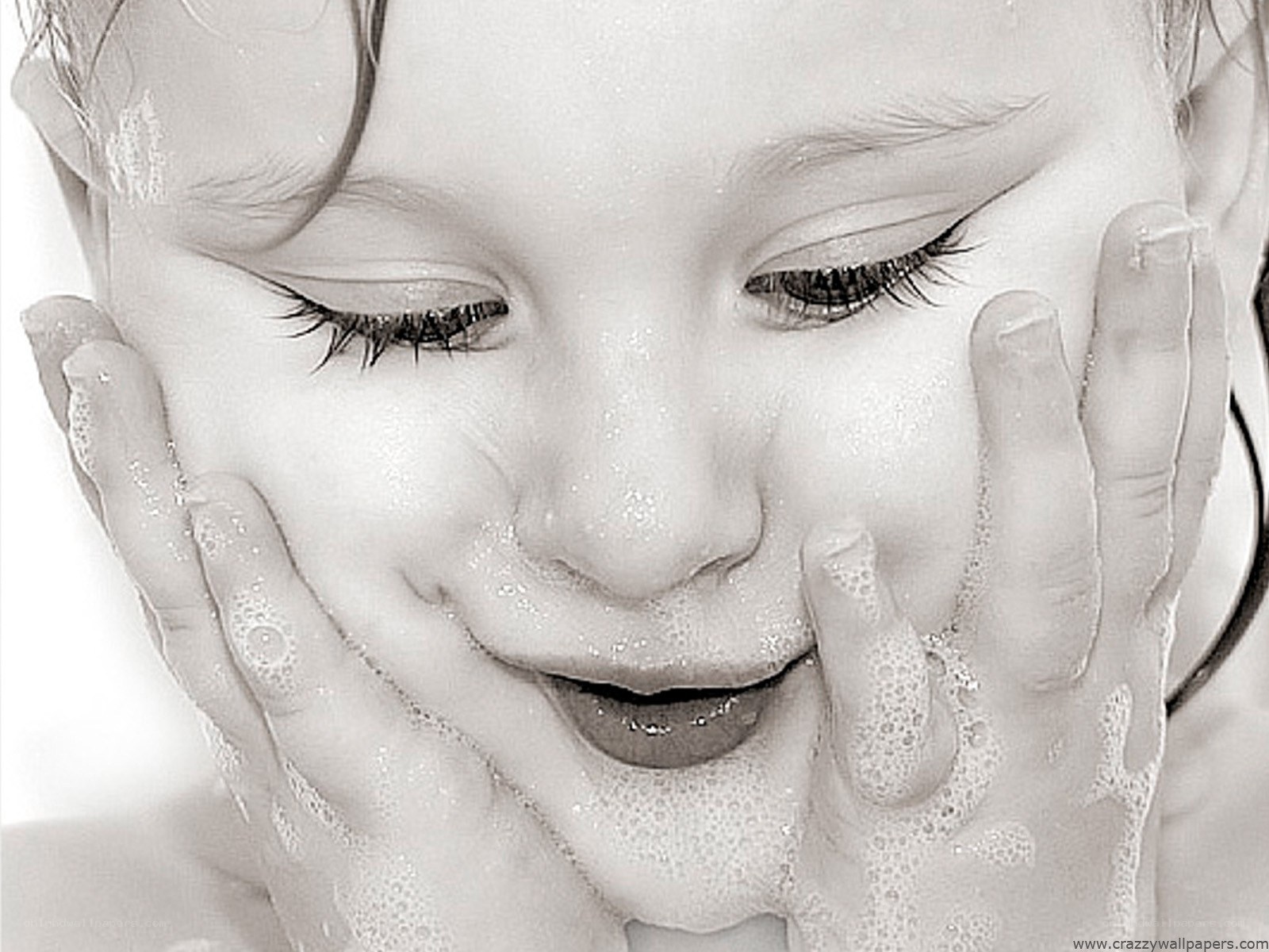 child washing face with soap