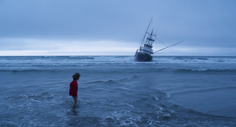 Child watches shipwreck at sea