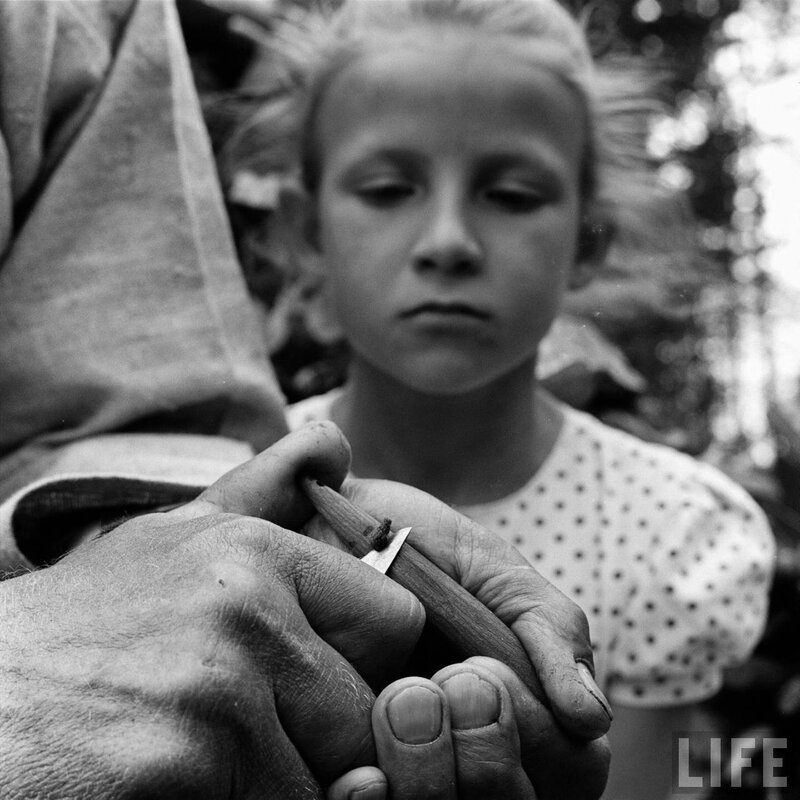 child watching hands carve wood
