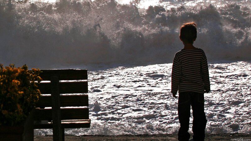 Child watching ocean waves