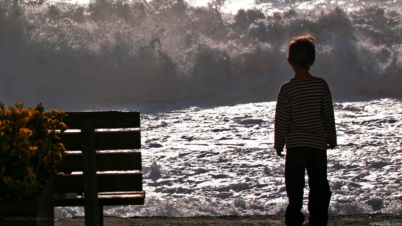 Child watching ocean waves