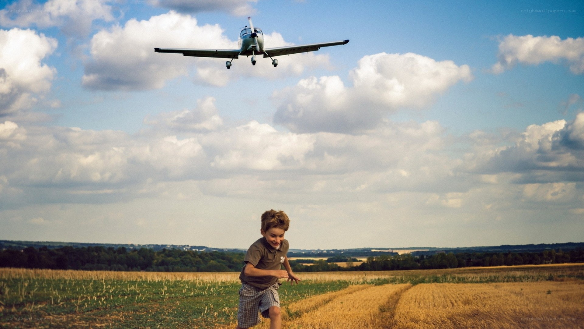 Child watching plane fly overhead