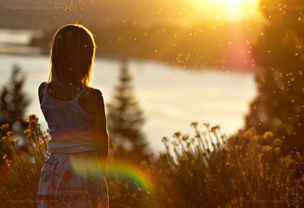 child watching sunset by water