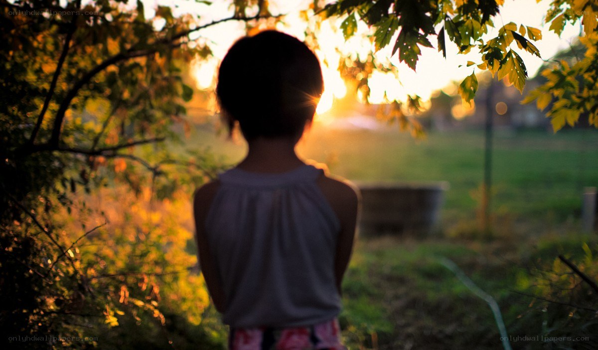 child watching sunset in garden