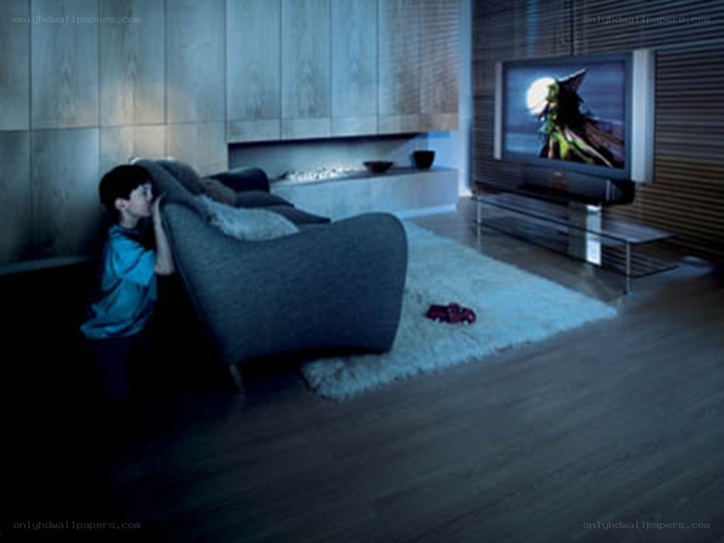 child watching tv in dark room