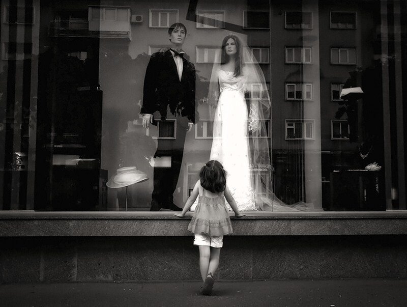 Child watching wedding mannequins