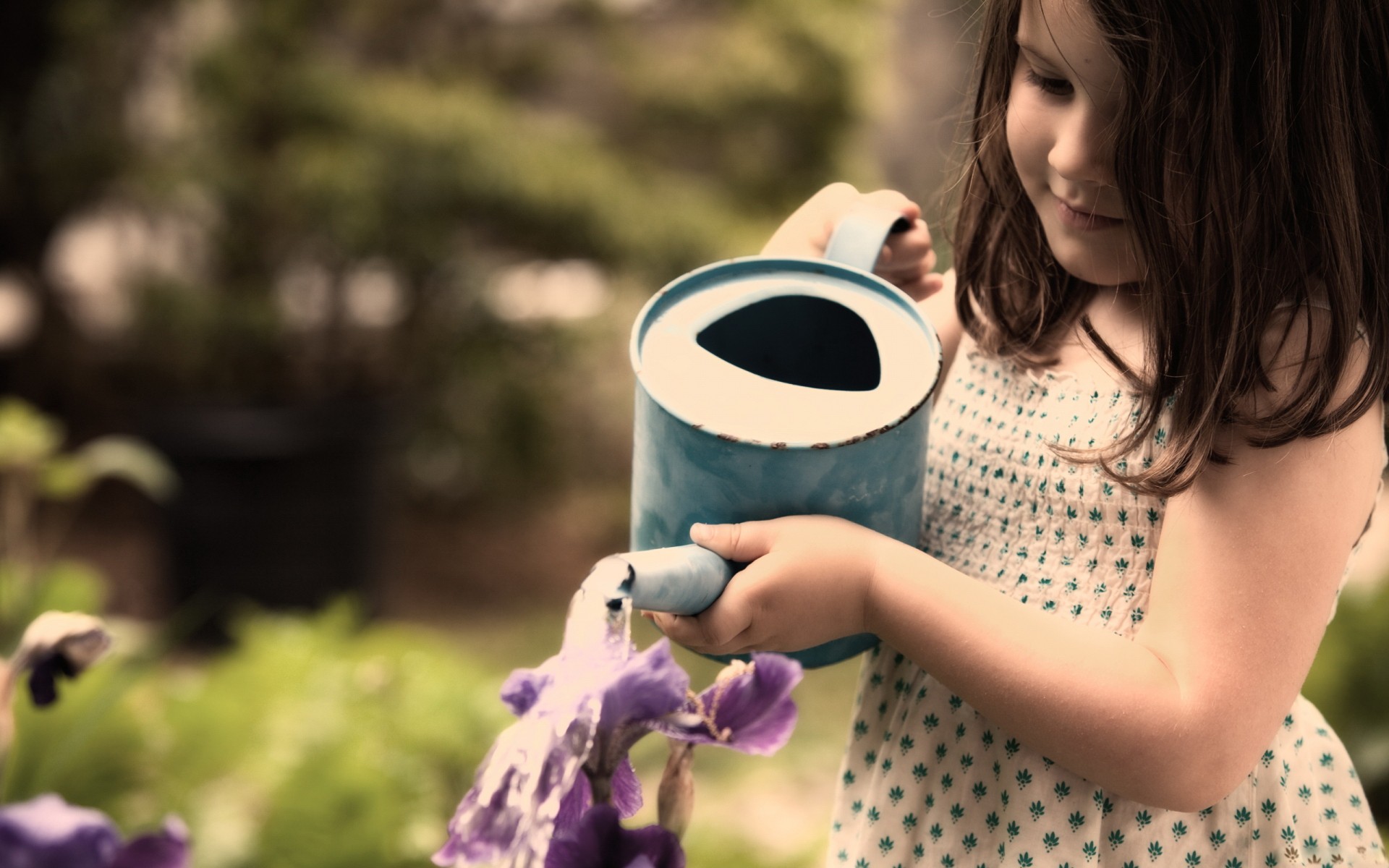 child watering flowers
