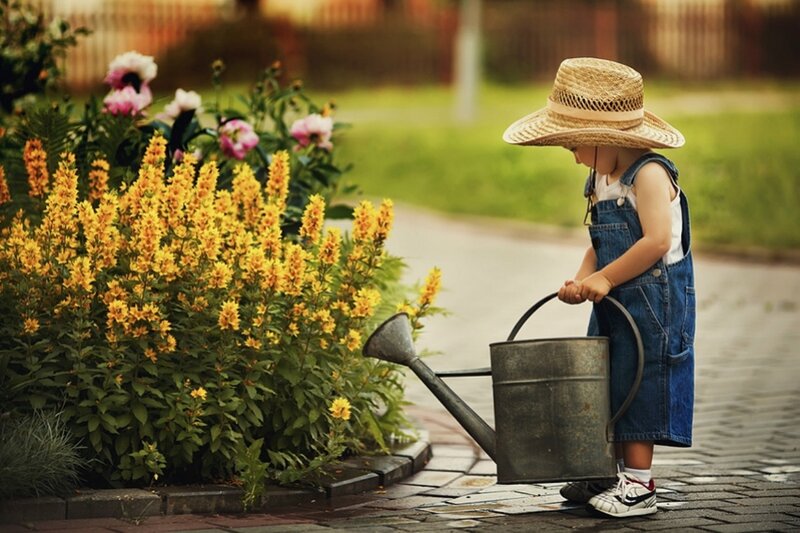Child Watering Flowers — Yellow