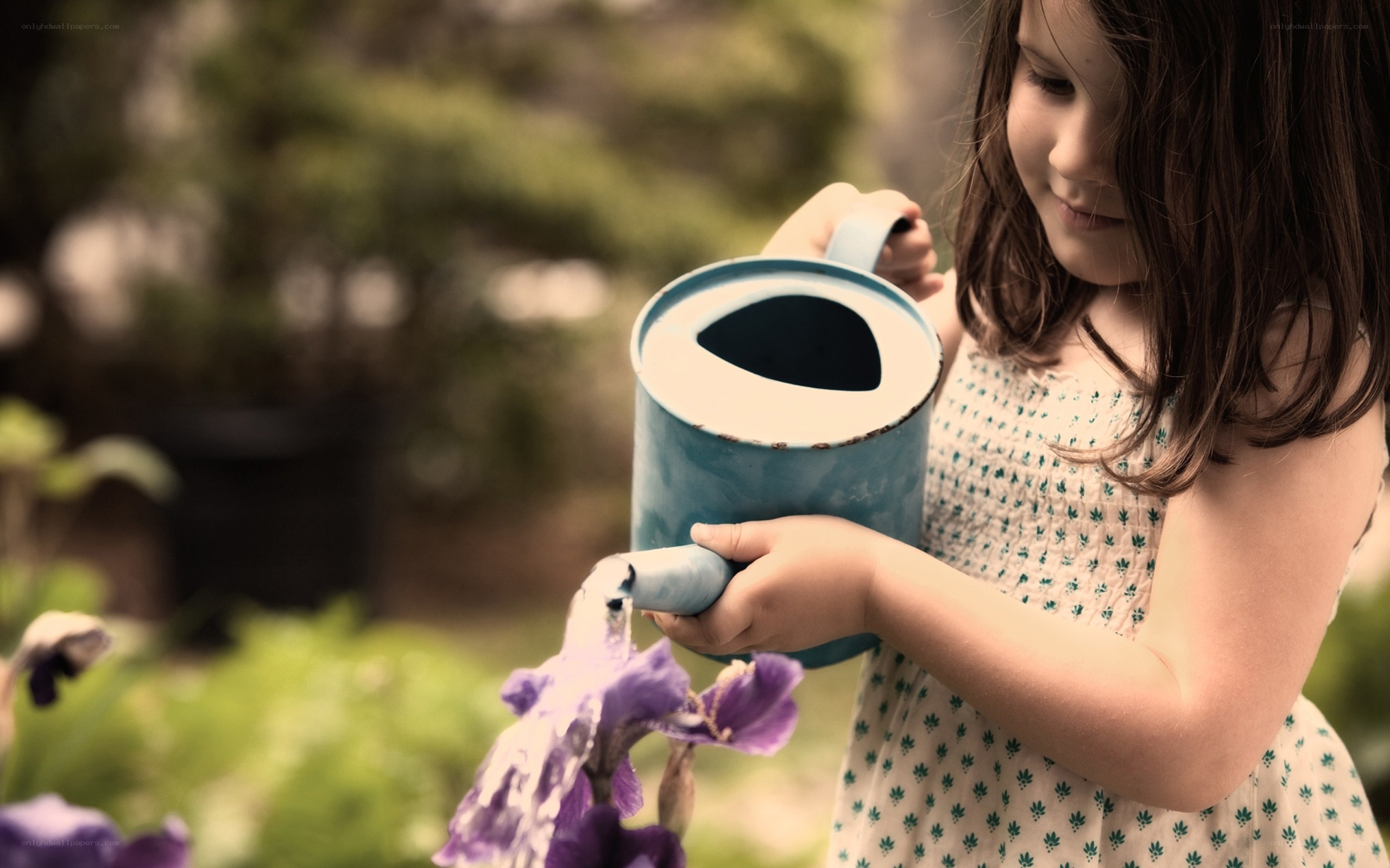 child watering flowers
