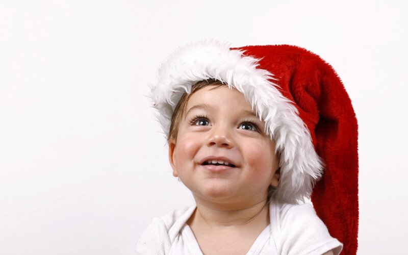 Child Wearing Santa Hat — Red, Joyful
