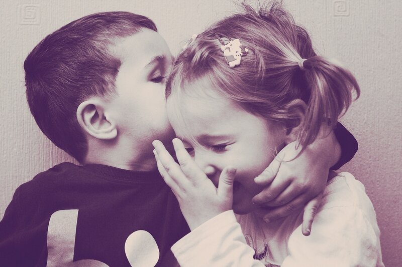child whispering to girl