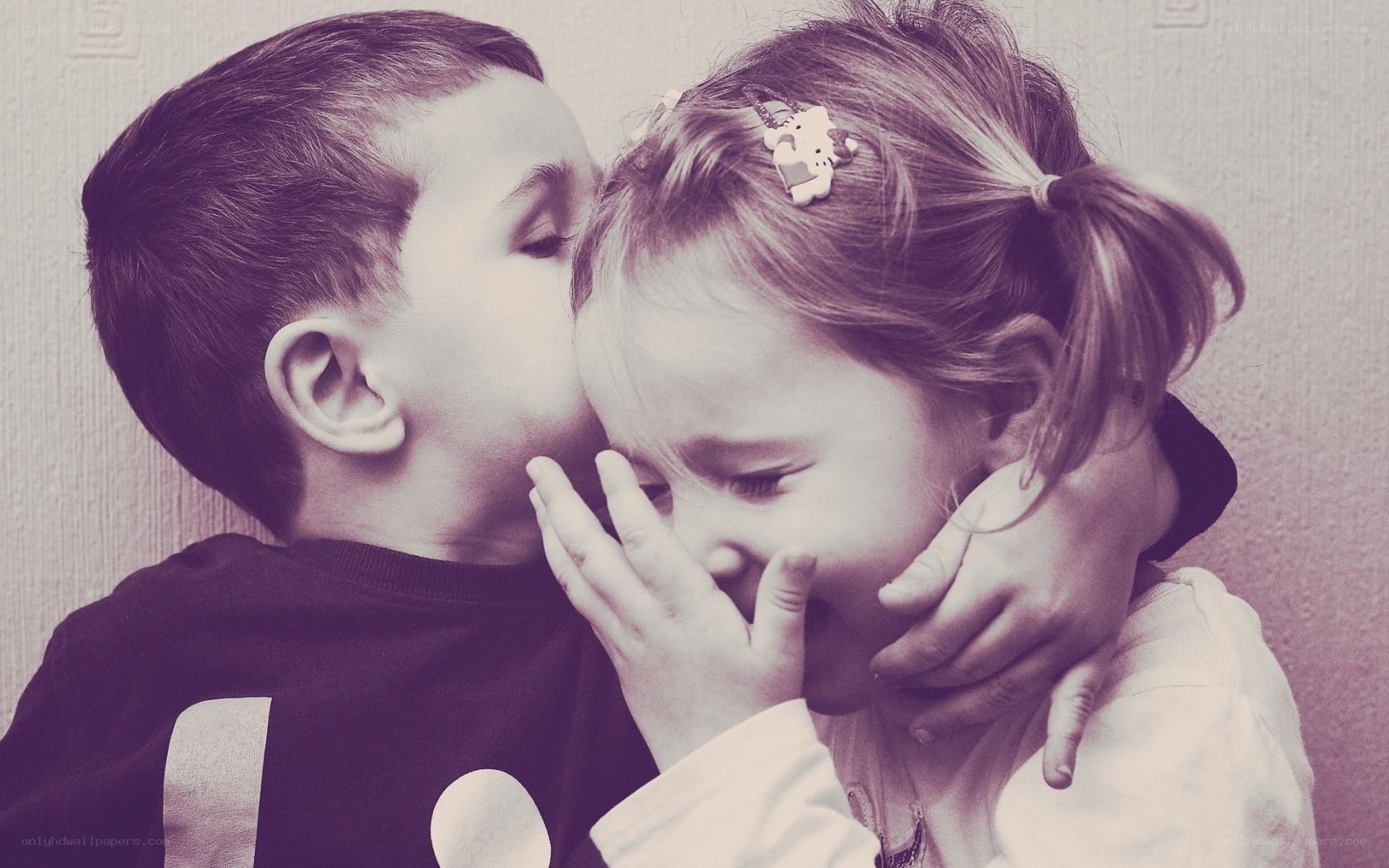 child whispering to girl