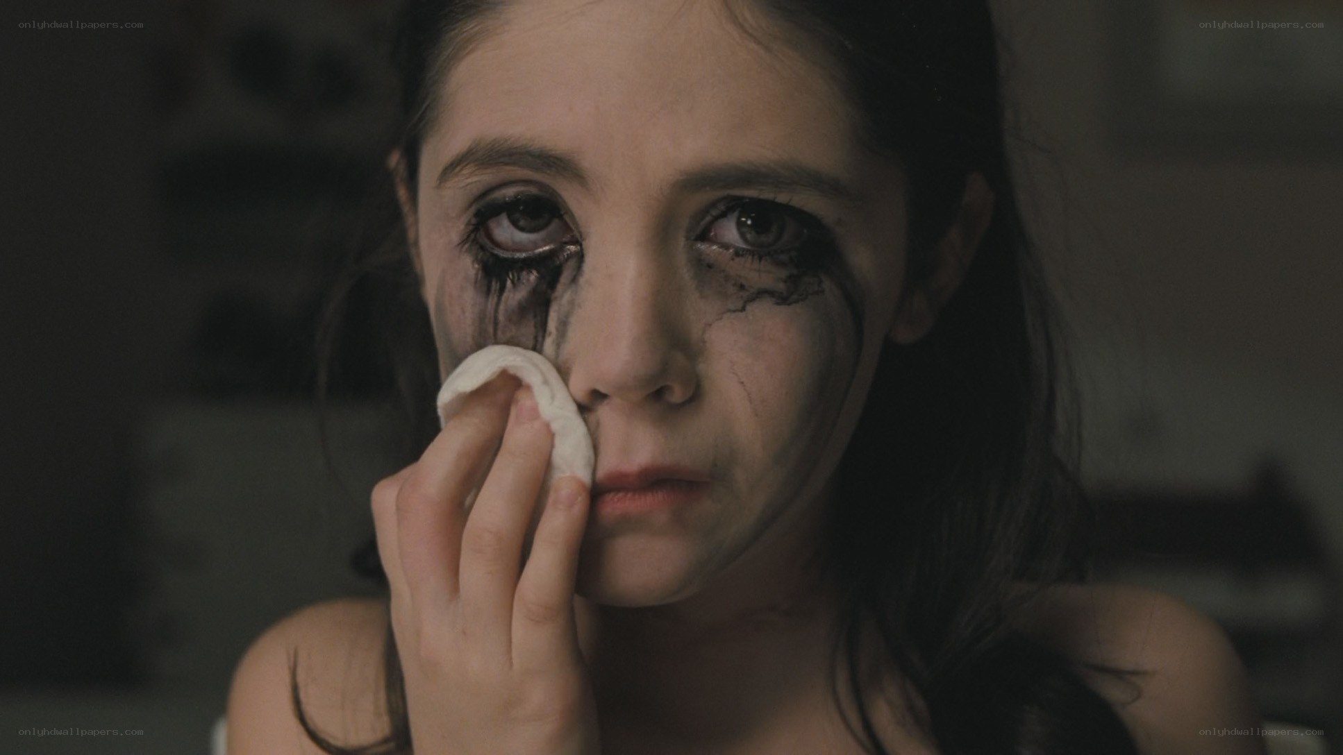child wiping makeup from face