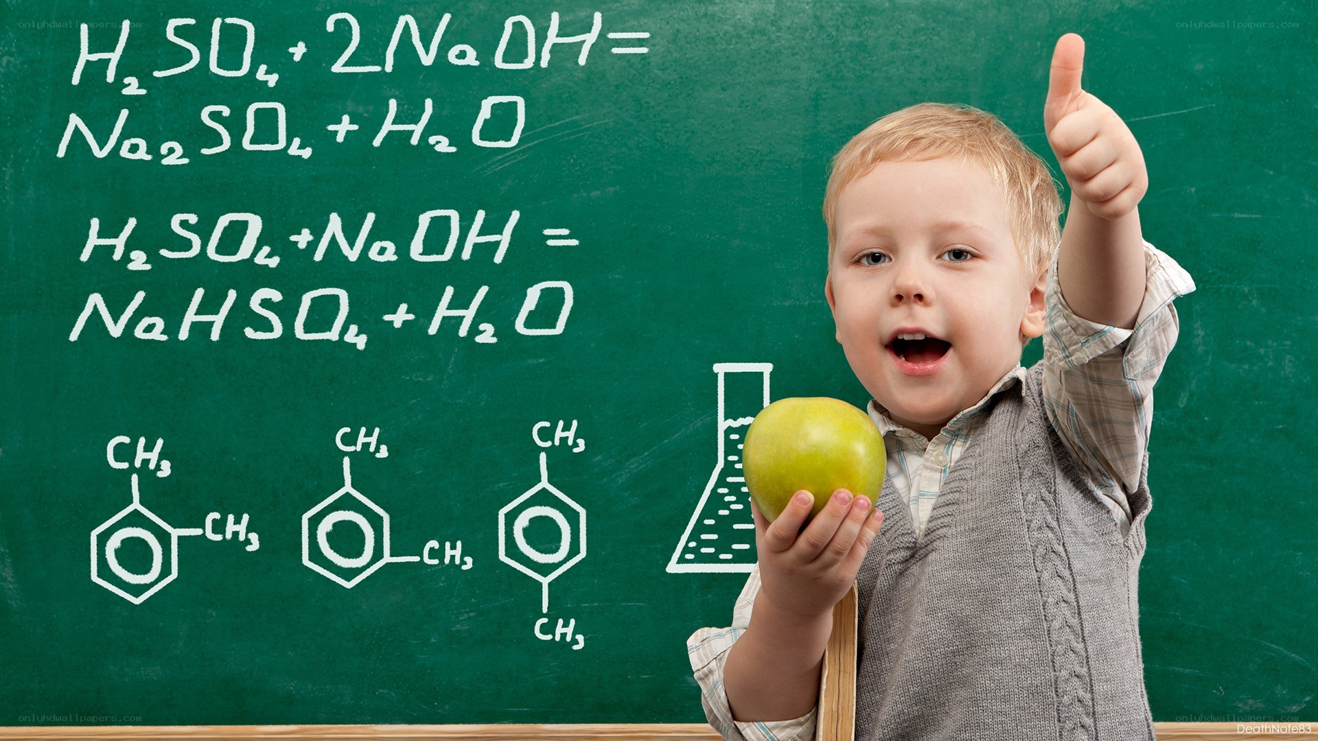 child with apple and chalkboard