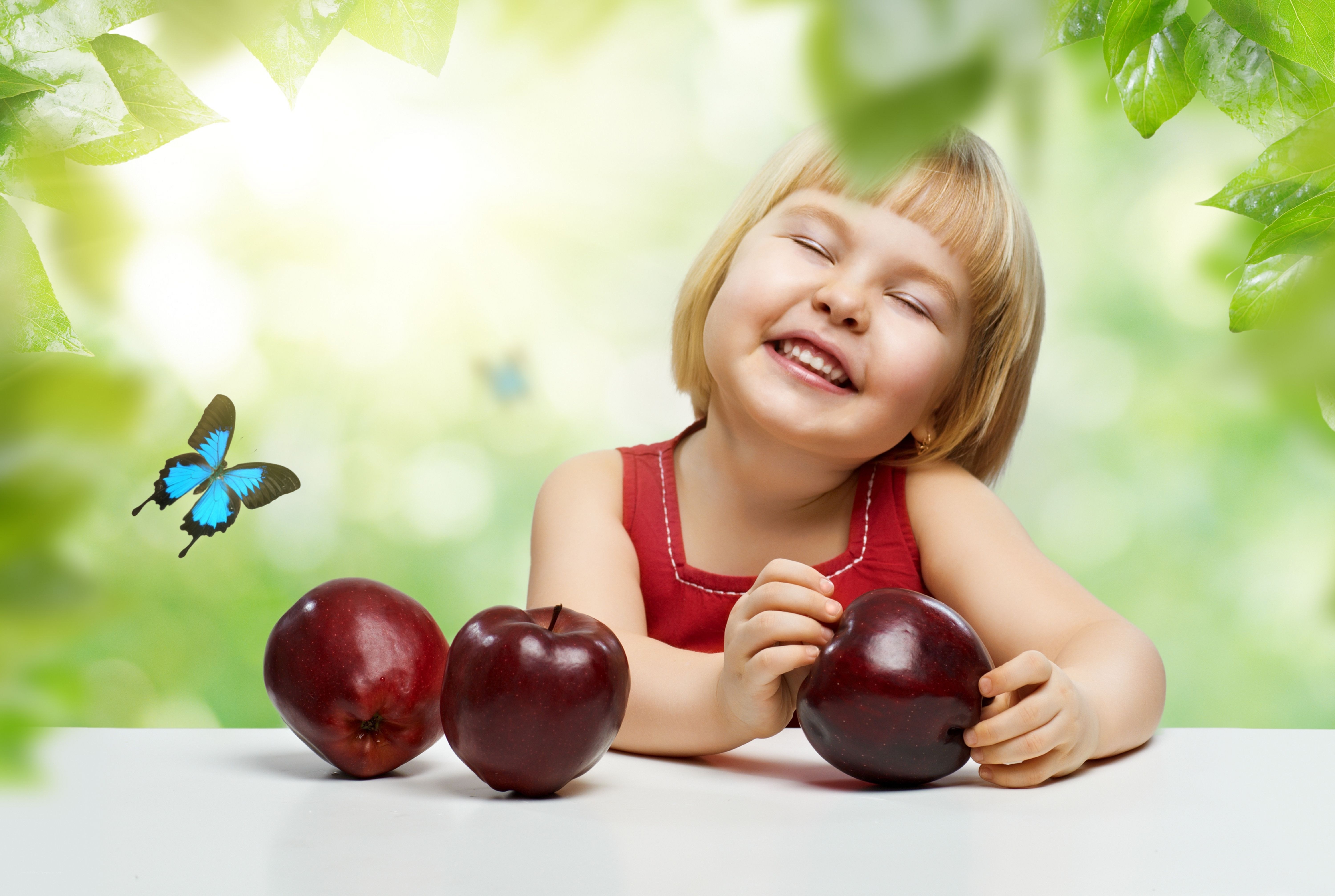 child with apples and butterfly