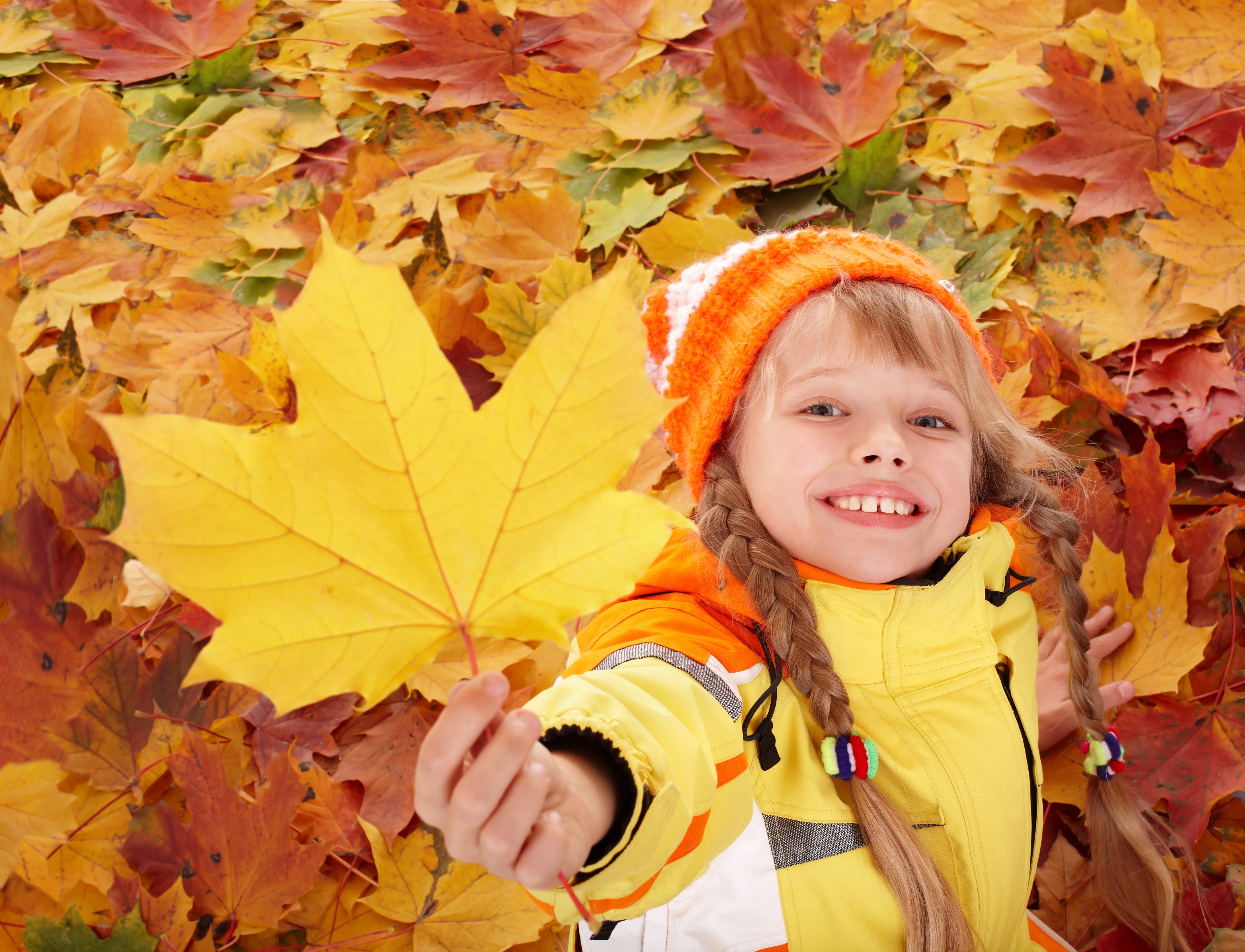 child with autumn leaf