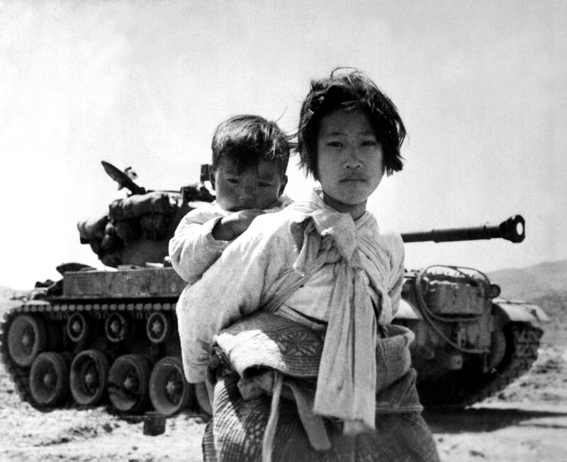 Child with baby near tank
