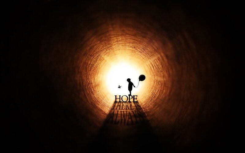 child with balloon in tunnel