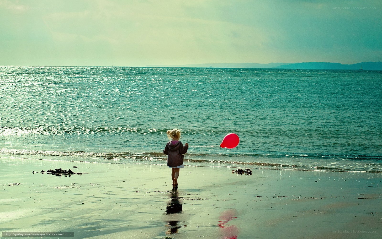 Child with balloon on beach
