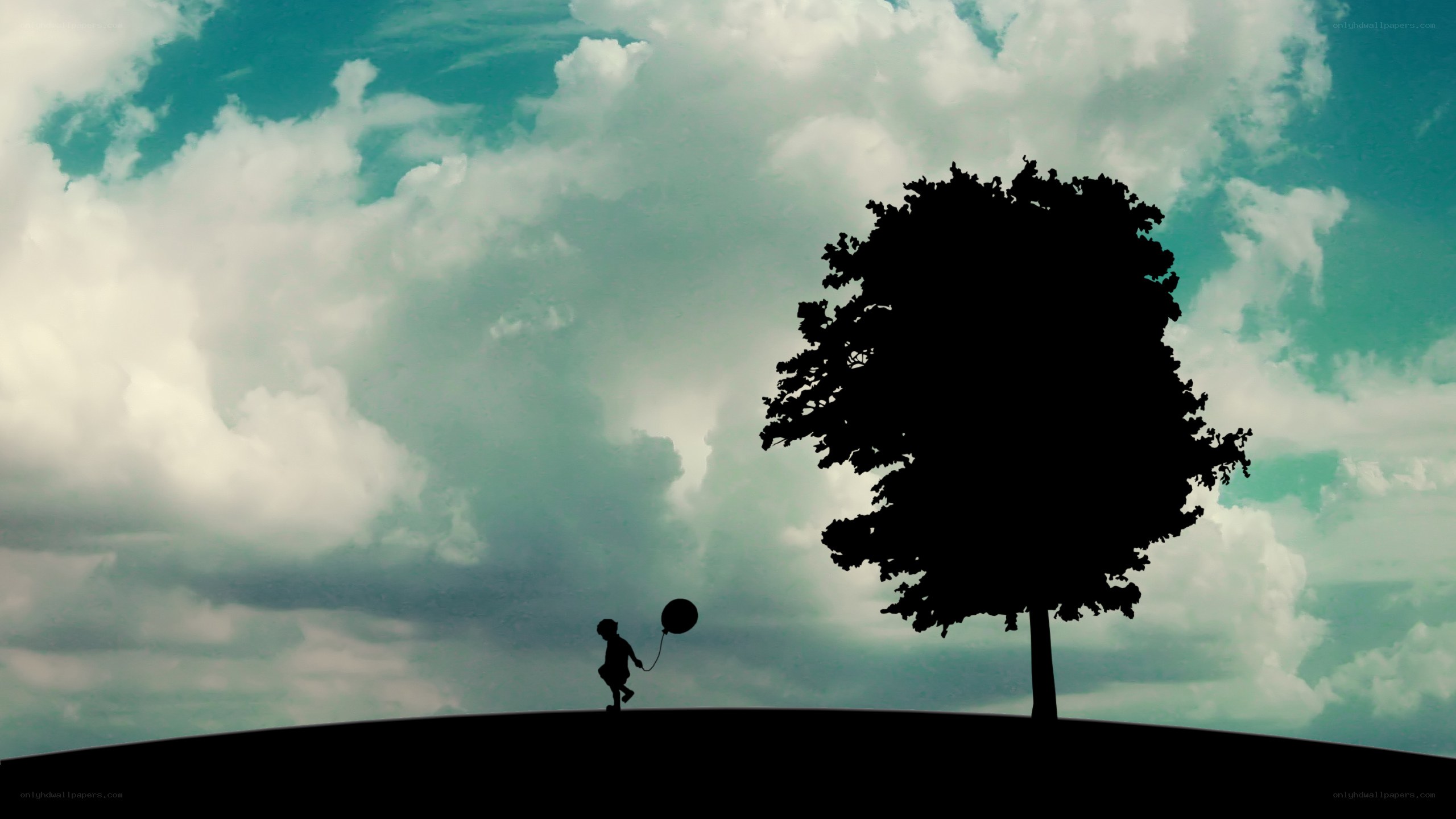 Child with balloon on hill