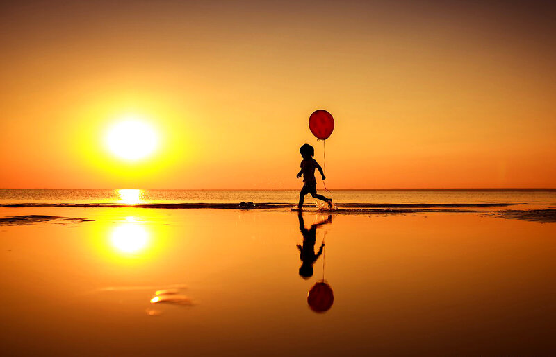 Child with Balloon — Orange, Serene
