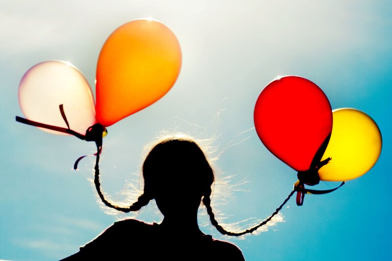 child with balloons silhouette