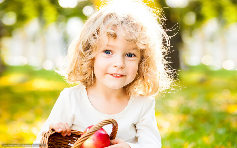child with basket of apples