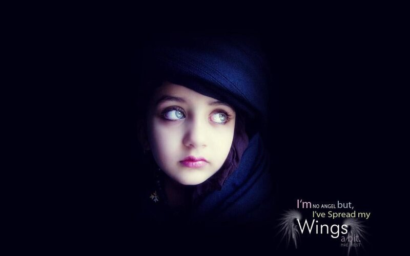 child with blue eyes and dark hood