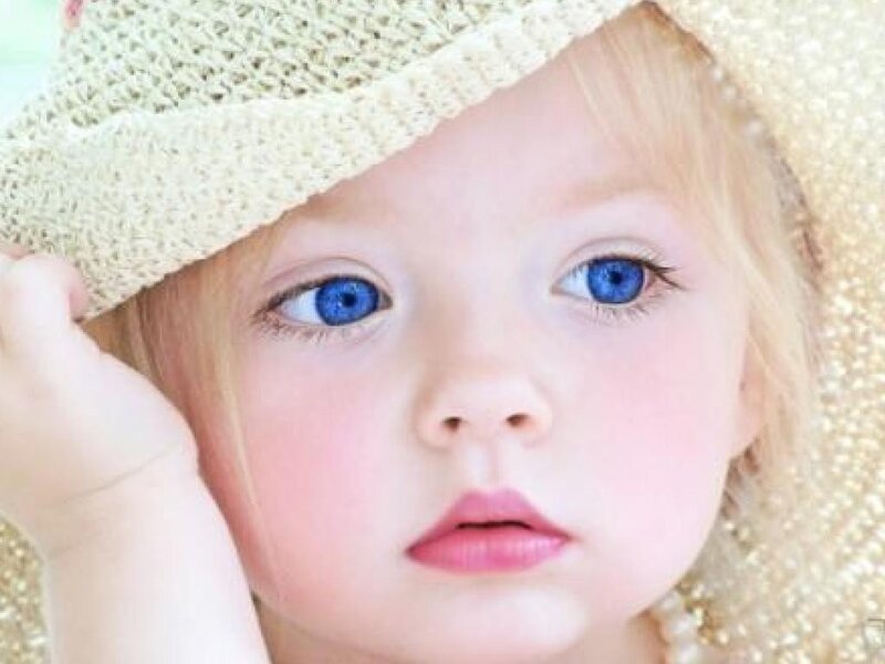 child with blue eyes and hat