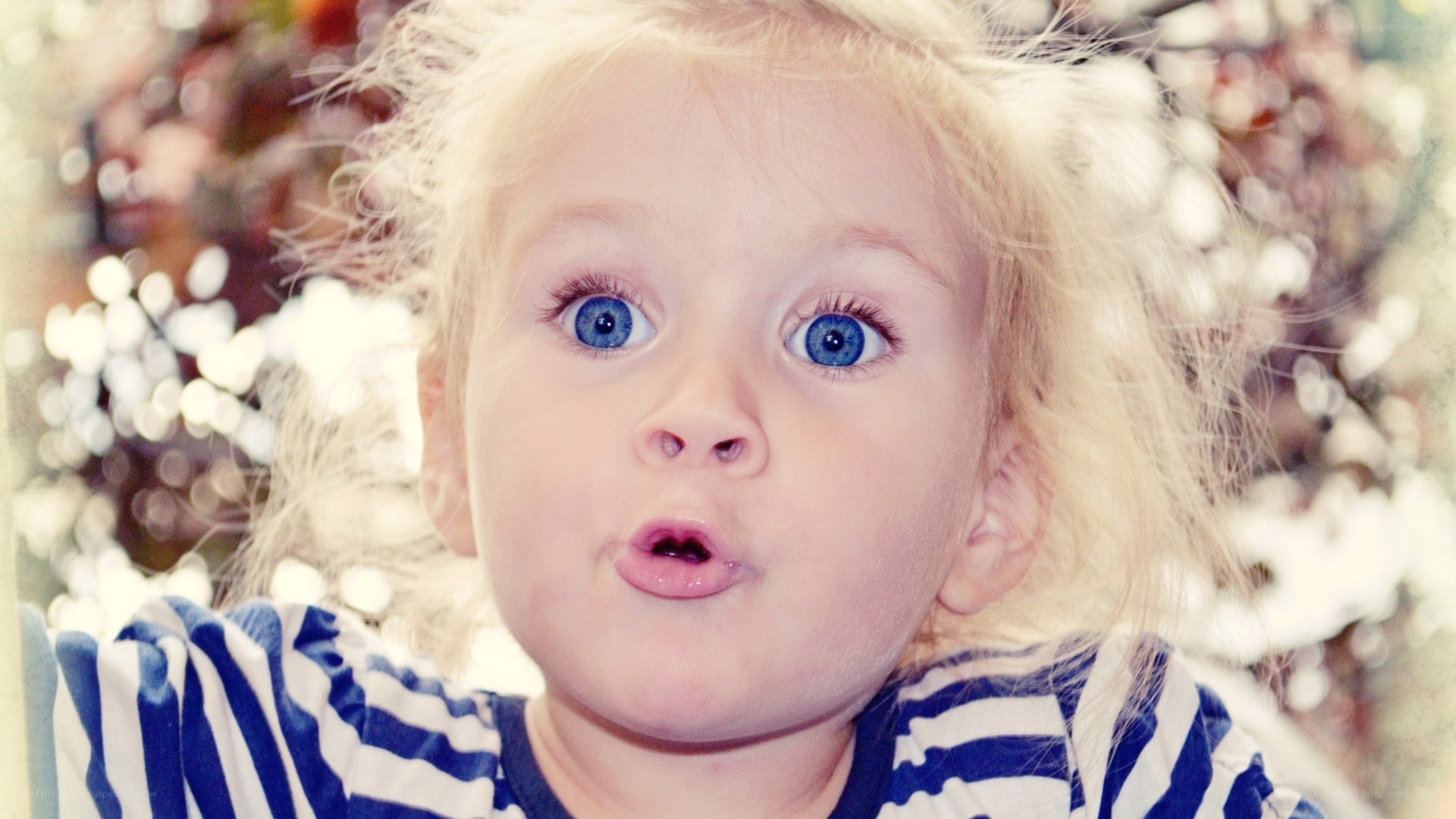 child with blue eyes looking up