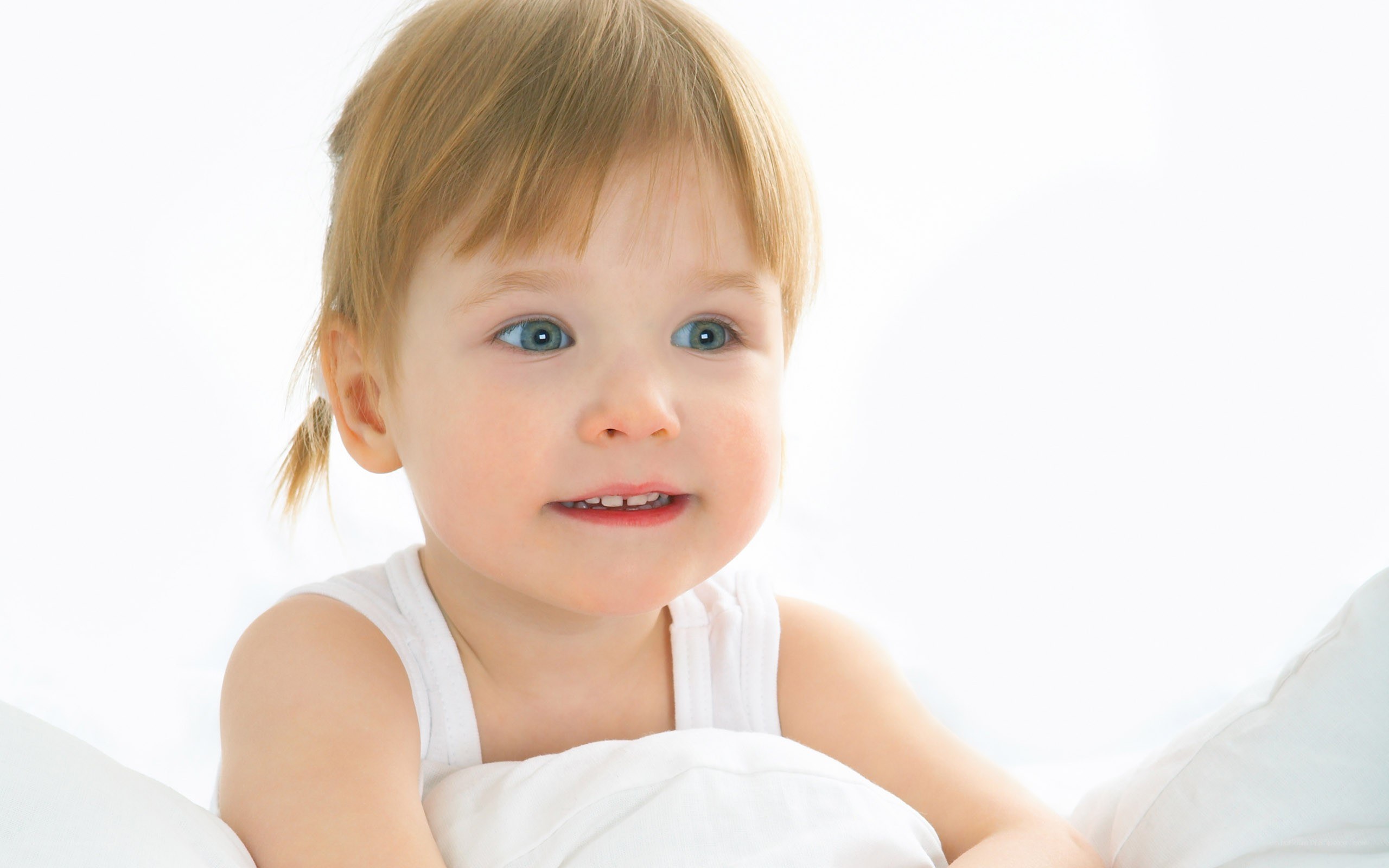 child with blue eyes smiling
