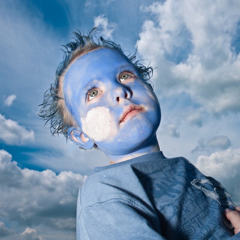 child with blue face paint