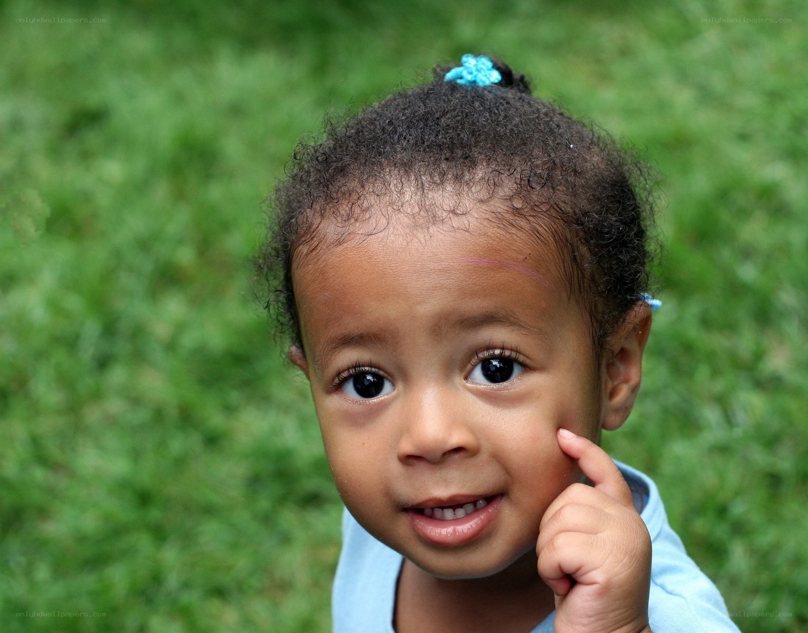 child with blue hair clip