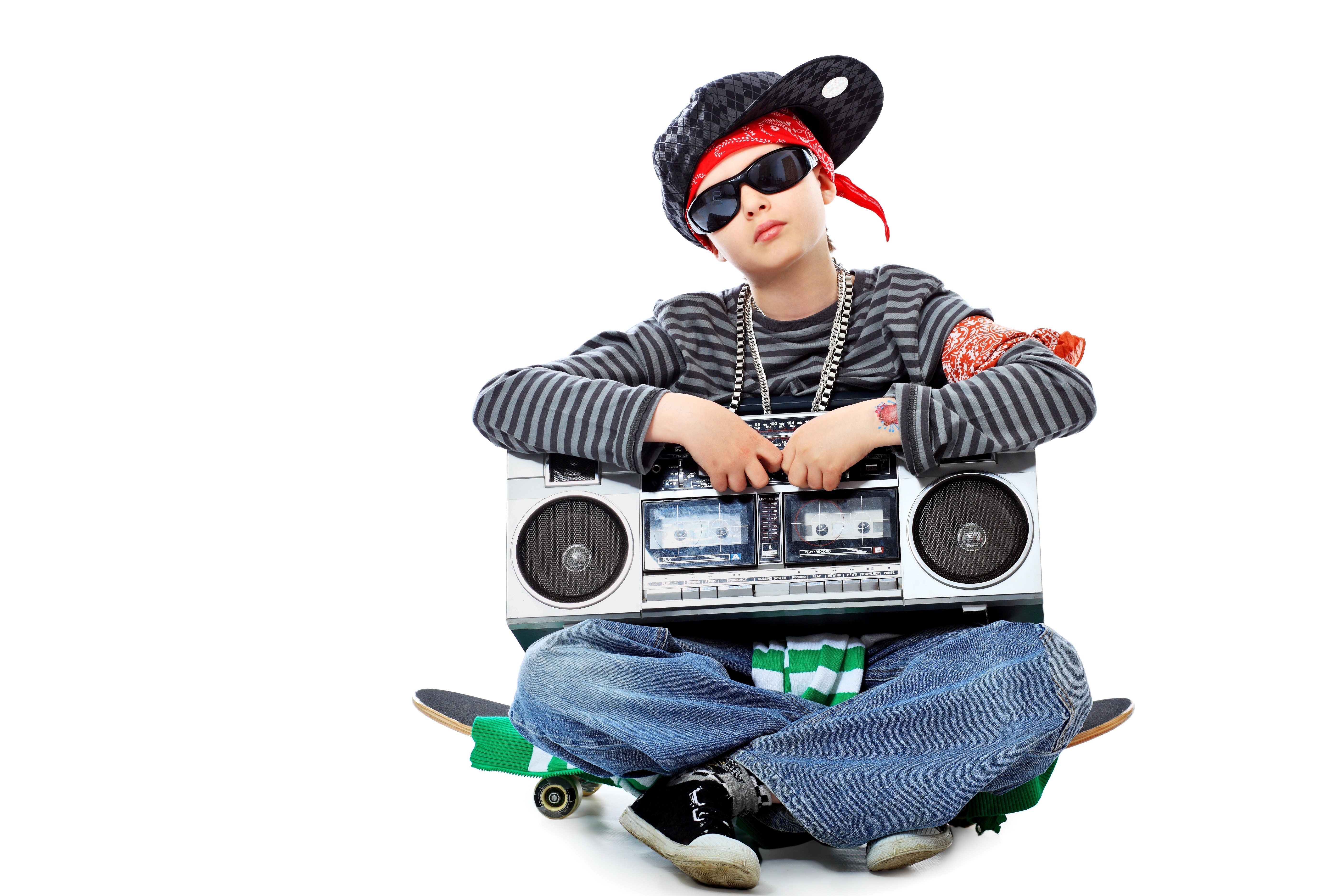 child with boombox and skateboard