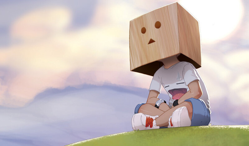 child with box head sitting