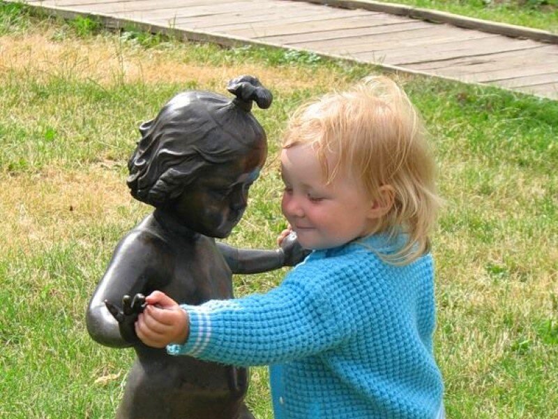child with bronze statue