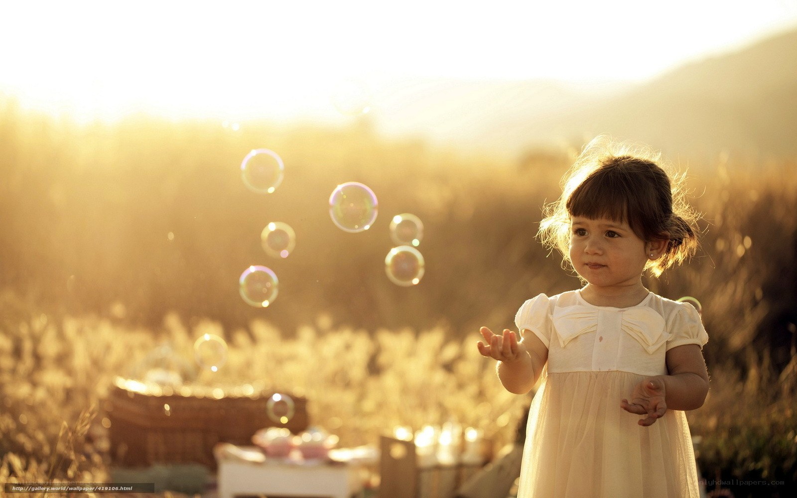 child with bubbles in field