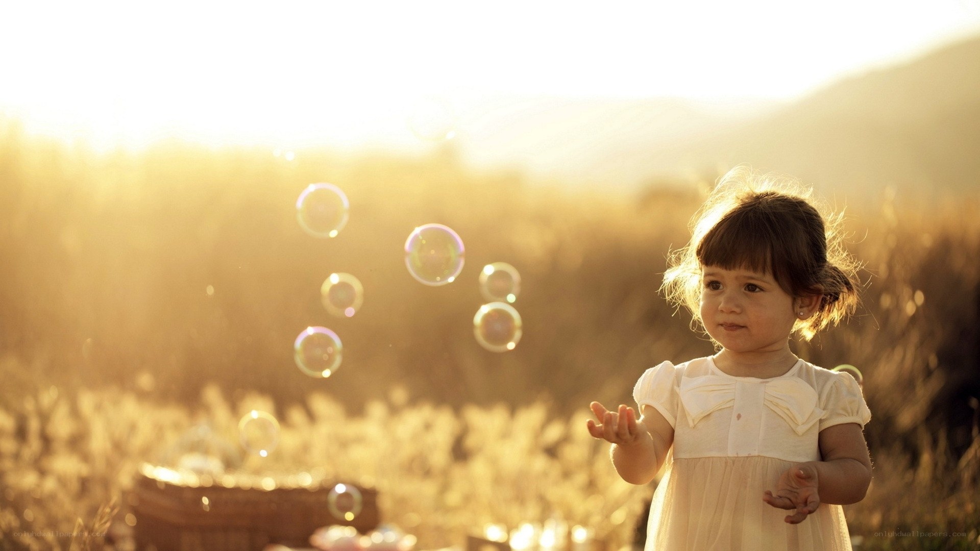 child with bubbles in field