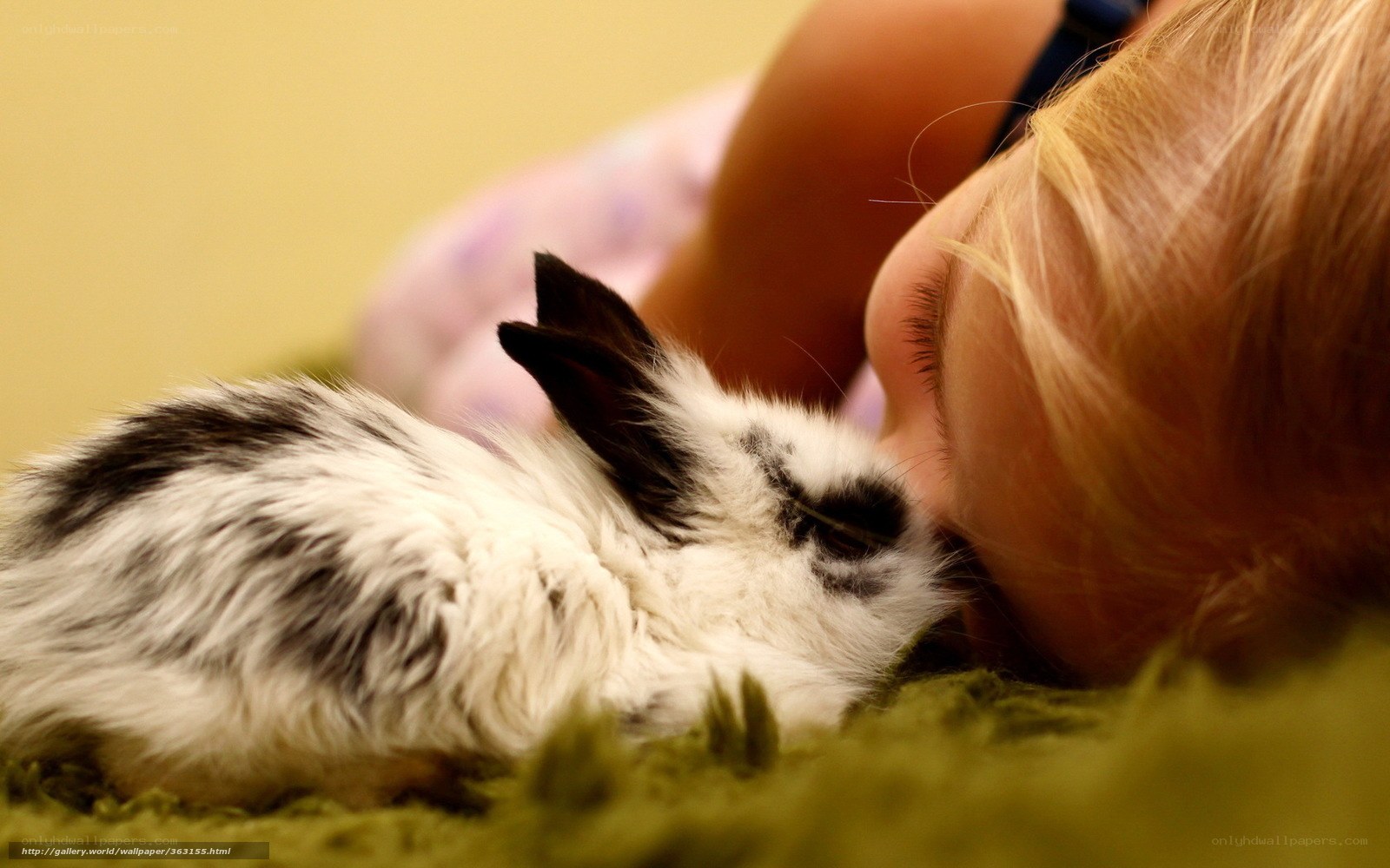 child with bunny on rug