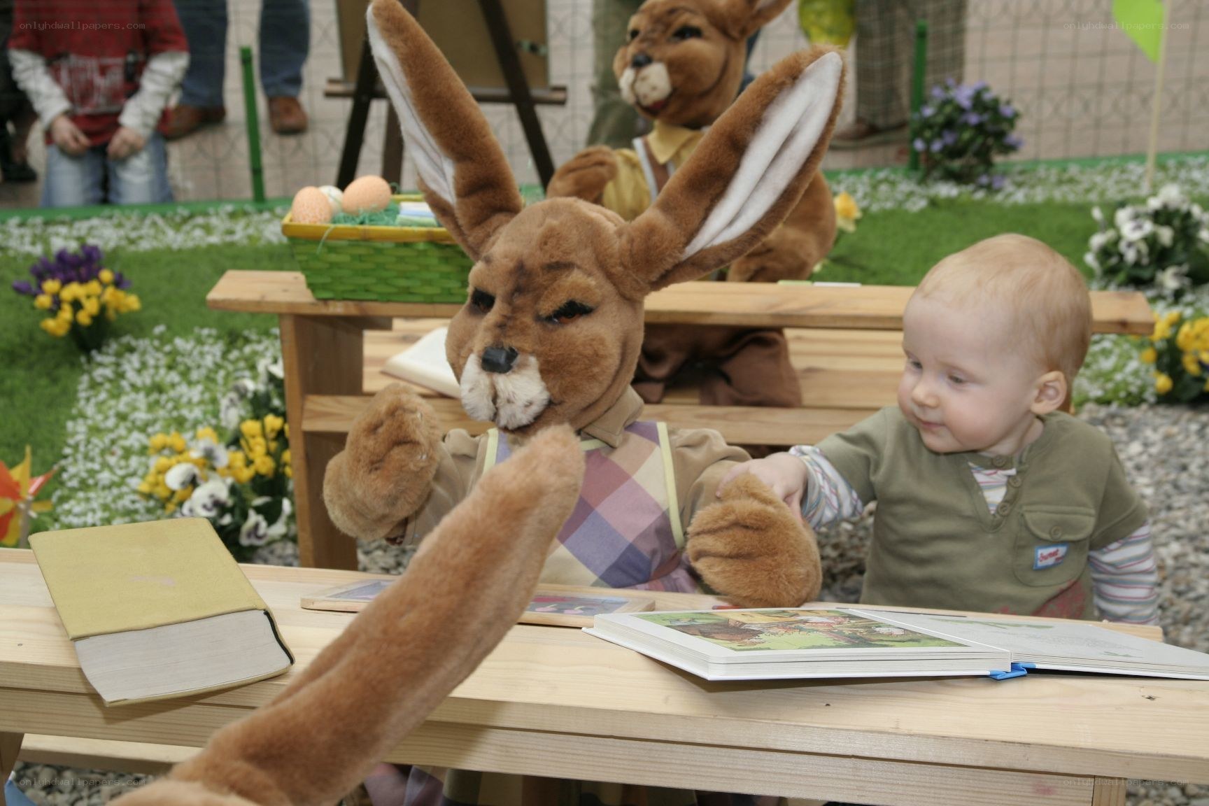 Child with bunny puppet at table