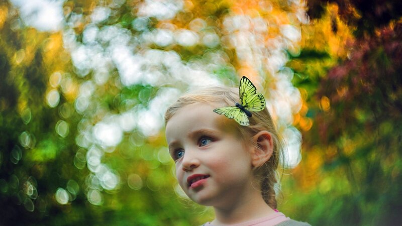 child with butterfly in hair