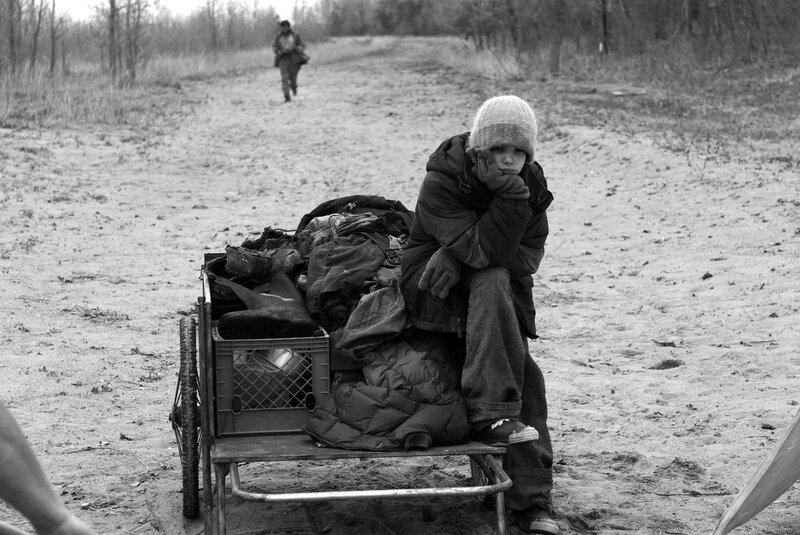Child with cart on dirt path