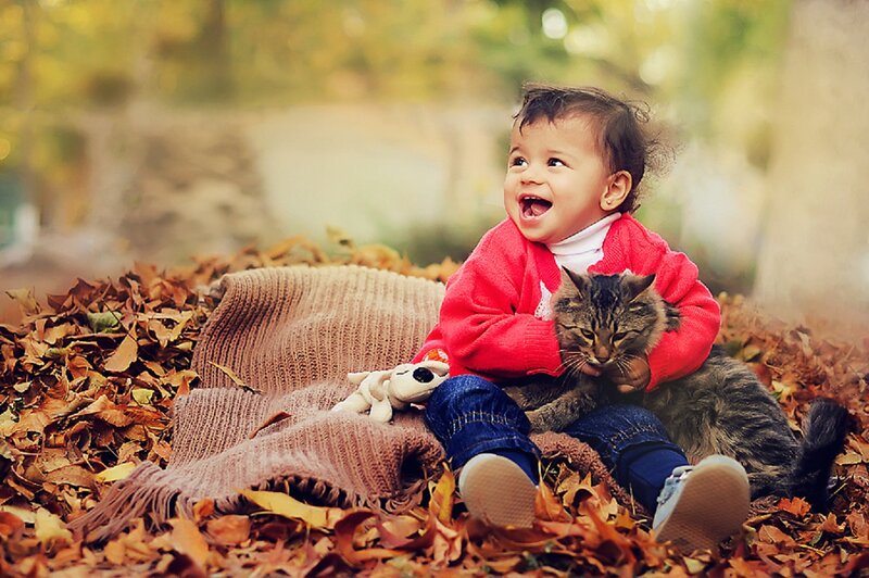 Child with Cat in Leaves