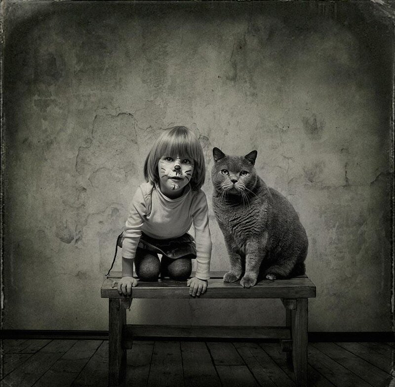 Child with Cat on Bench