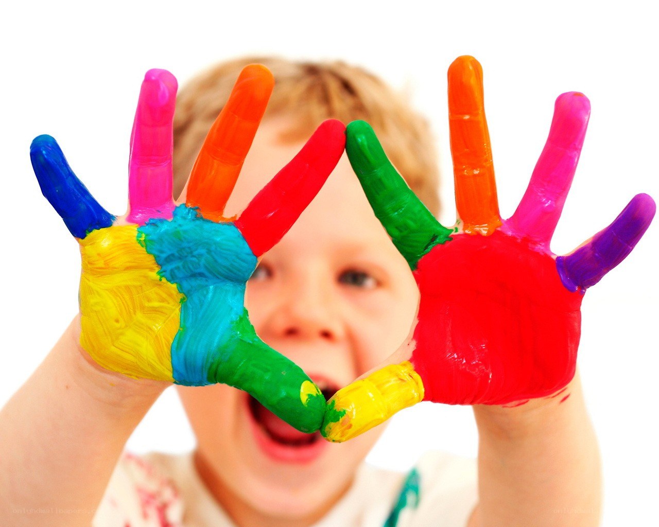 child with colorful painted hands