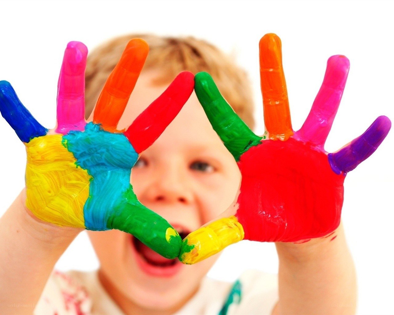child with colorful painted hands